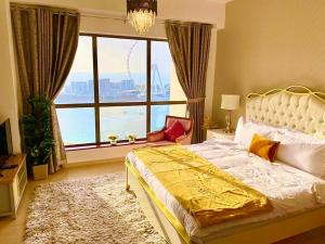 a bedroom with a bed and a large window at Luxury Casa - Royal Sea View Apartment JBR Beach 2BR in Dubai