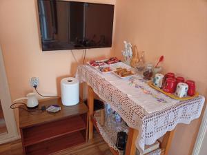 a table with a white table cloth on it at "Pivnica i smestaj Jovanovic"- Rogljevacke pivnice in Rogljevo