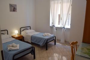 A bed or beds in a room at NaturAmare Apartments Palinuro