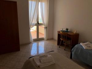 A bed or beds in a room at NaturAmare Apartments Palinuro