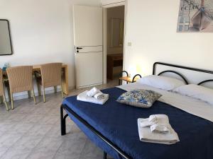 A bed or beds in a room at NaturAmare Apartments Palinuro