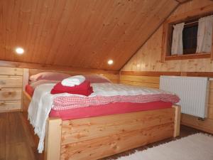 a bedroom with a bed in a wooden cabin at Chatka Zornica in Ždiar