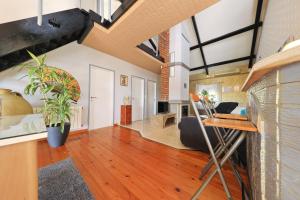 una sala de estar de planta abierta con suelo de madera y techos abovedados. en Apartman Gosselin Korculanin, en Poljica