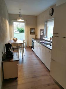 a kitchen with a table and a dining room at Gästehaus Vergissmeinnicht in Guteborn