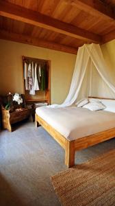 a bedroom with a bed with a canopy at Una casa tra gli alberi in Tresivio