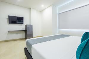 Llit o llits en una habitació de Ayenda Hotel Trinidad