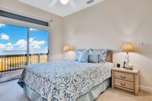 a bedroom with a bed with a view of the ocean at Cocoa Mansion in Cocoa Beach
