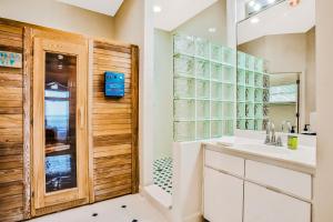 a bathroom with a sink and a mirror at Cocoa Mansion in Cocoa Beach +35 photos
