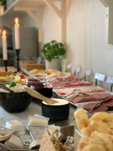 a table with many different types of food on it at Ludvika Stadshotell in Ludvika