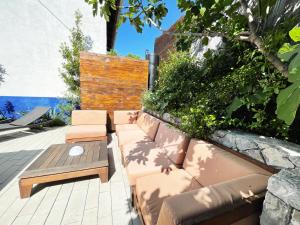 a patio with a bench and a table at Apartments Monika Bed & Breakfast in Punat