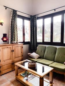 Hotel Valdevécar في بني الرزين: غرفة معيشة مع أريكة وطاولة قهوة
