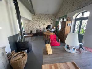 a living room with a wood stove and a table at Villa au centre de Nîmes in Nîmes