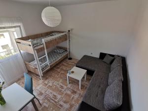 a living room with a couch and a bunk bed at Ema & Mila 2 in Knin