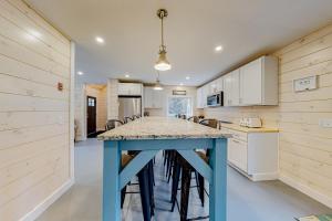 a kitchen with a blue table and chairs in it at Creek Cottage in Bass Harbor