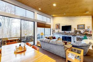 a living room with a couch and a fireplace at Delightful Seclusion in Stratton