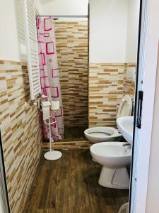 a bathroom with two toilets and a sink at FAR WEST in Ginosa +32 photos