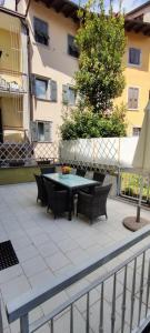 a patio area with a patio table and chairs at Dolce Riva Downtown apartment in Riva del Garda