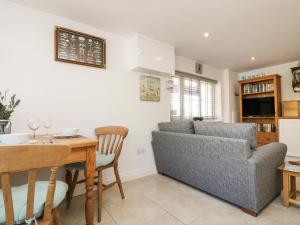 a living room with a couch and a table at Seascape in Porthcurno