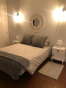 a bedroom with a bed and a mirror on the wall at Casa da Encosta Douro Valley in Pinhão +25 photos
