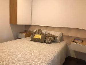 a bedroom with a bed with two pillows on it at Pousio- Rural Appartments in Vagos +28 photos