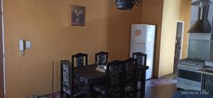 a kitchen with a table and chairs and a refrigerator at Los Nietos Temporario in Mendoza