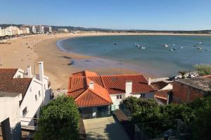 a view of a beach with boats in the water at Aparatmento T3 com vista mar em condomínio de Luxo in São Martinho do Porto