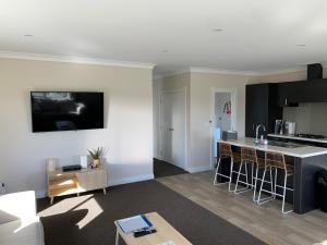 a kitchen and a living room with a kitchen and a counter at Brixton farm stay in Waitara