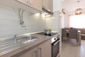 a kitchen with a sink and a counter top at Apartment Oleander in Punat