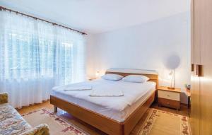 Ein Bett oder Betten in einem Zimmer der Unterkunft Apartments Vukelic