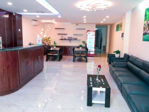 a living room with a couch and a bar at Victory Airport Hotel in Ho Chi Minh City