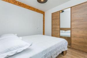 a bedroom with a large white bed and a mirror at House Mali dvori in Krivodol +37 photos