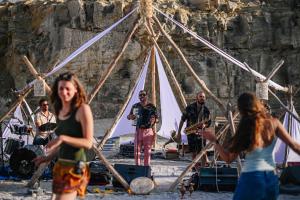 a group of people standing in front of a music band at Selina Ramon in Mitzpe Ramon