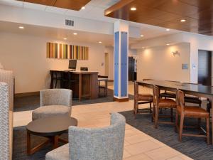 a meeting room with a table and chairs at Holiday Inn Express & Suites - Brighton South - US 23, an IHG Hotel in Brighton