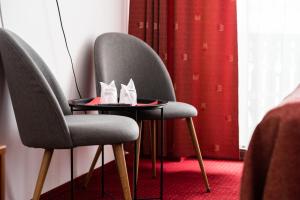 two chairs and a table with shoes on it at Serena Guesthouse Bran in Bran