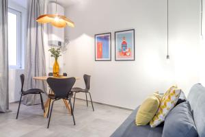 a living room with a couch and a table at Stylish loft in the city center in Trieste