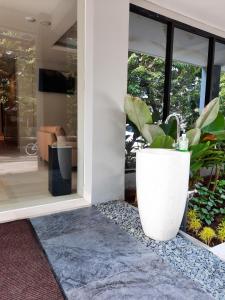 a house with a plant on the front door at Votel Krakatau Boutique Hotel Semarang in Semarang