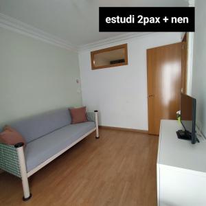 a living room with a couch and a tv at Apartament Berga in Berga
