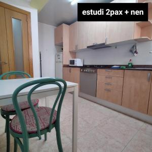 a kitchen with a table and chairs in a room at Apartament Berga in Berga