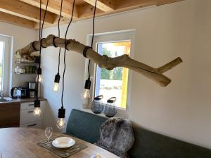 a dining room with a tree branch hanging from the ceiling at Casa Blu Kärnten - One Holiday in Three Countries - Cold&Hottub, Sauna - Piste in Arnoldstein