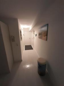 a white hallway with a hallway leading to a white door at Flensburg Zentrum 69 01 in Flensburg