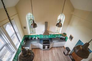 an overhead view of a kitchen with a stove and two windows at Old Chapel in Cheltenham