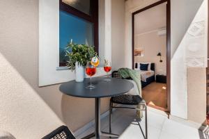 a small table in a room with two glasses of wine at Sunset Residence Rovinj in Rovinj +28 photos