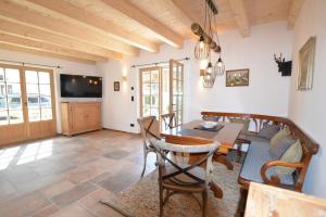 a kitchen and dining room with a table and chairs at Chalet Kaisereck in Reit im Winkl