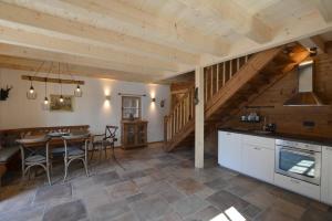 a kitchen and dining room with a table and chairs at Chalet Kaisereck in Reit im Winkl