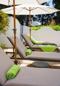 a group of lounge chairs with umbrellas at Casa Felizia in Els Poblets