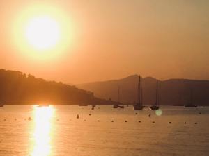 a group of boats in the water at sunset at Stone studio in Saint-Tropez