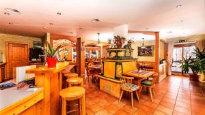 a kitchen with a stove and some tables and chairs at Alfaierhof-Bergheimat in Gschnitz