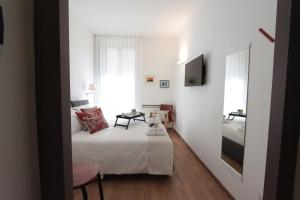 a small bedroom with a bed and a mirror at Palazzo Pinto B&B - Brindisi (Italy) in Brindisi