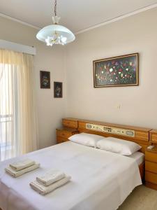 a bedroom with a bed with two towels on it at Hygge Retreat in Preveza