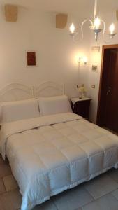 A bed or beds in a room at B&B DIMORA PALMIERI